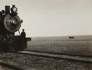 Speed Prints: Two men standing on the cow-catcher of a Great Northern Railroad locomotive on the Montana prairie