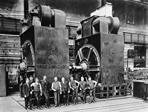 Generators Prints: Nine men in suits are dwarfed by two massive dynamos