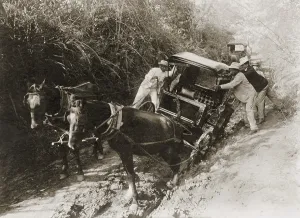 Well Dressed Prints: Three men in suits push a horse-drawn carriage stuck in the mud on a Puerto Rican road in 1912
