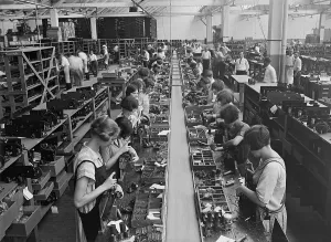 Broadcasting Prints: Men and women working on a radio assembly line in Washington D.C. area. 1925