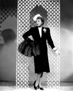 Muff Prints: MIDNIGHT, Claudette Colbert, in a black wool suit by Irene