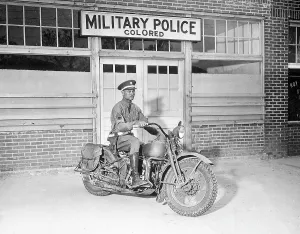 Negro Prints: A Military Police officer posed on his motorcycle before making his rounds