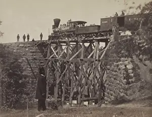Technology Prints: US Military Railroad locomotive and box cars on a high section of track