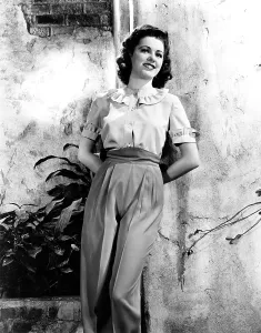 Ruffled Collar Prints: MISSION TO MOSCOW, Eleanor Parker, in an ivory blouse and red slacks, 1943
