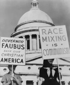 Arkansas Prints: A mother and her son hold signs equating school integration with communism and segregation with Christianity