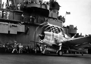 Bombers Prints: Motion of its propellers causes an aura to form around this F6F Hellcat fighter on USS YORKTOWN