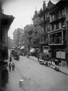 Mott Street in New York City's Chinatown presents a cosmopolitan scene mixing Asian and American-European dress and faces