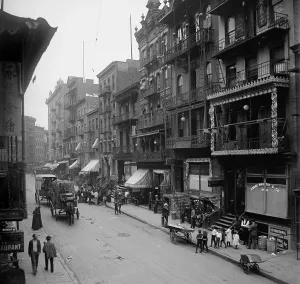 Mott Street in New York City's Chinatown presents a cosmopolitan scene mixing Asian and American-European dress and faces