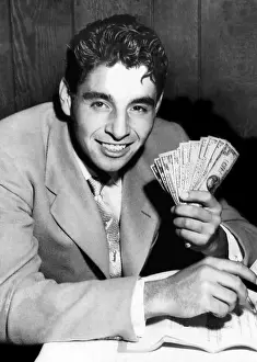 Images Dated 25th March 2007: National amateur tennis champion Richard Pancho Gonzales holds money after signing a 1-year contract to tour
