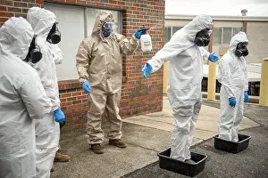 Epidemic Prints: National Guardsmen of a COVID-19 response team are disinfected in Birmingham