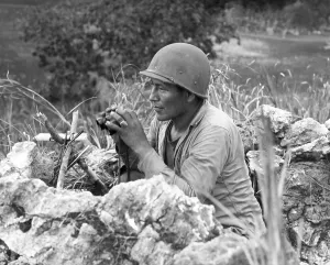 Encryption Prints: Native American Marine Code Talker at an observation post overlooking the city of Garapan