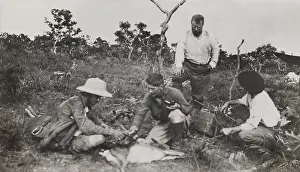 Naturalists of the Smithsonian-Roosevelt African Expedition, squatting around a dead animal. L-R: Kermit Roosevelt, Edmund Heller, Theodore Roosevelt (standing), unidentified