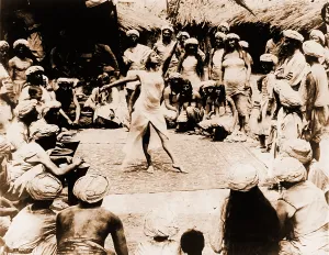 Folk Prints: Nautch girl, a young Indian dancing on rug with Hindu men and women watching. India, 1914