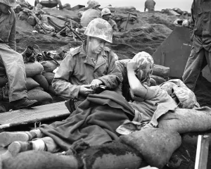 First Aid Prints: Navy doctor and corpsman treat a wounded Marine on Iwo Jima