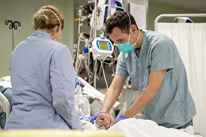 Patient Prints: Navy Lt. Wade Miller treats a patient aboard the USNS Mercy in Los Angeles, April 4, 2020