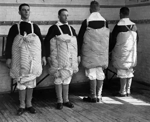Images Dated 3rd December 2012: Navy recruits with their mattresses tied to them to serve as life preservers