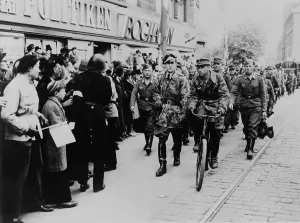 Grim Prints: Nazi soldiers march down a commercial street in German-occupied Denmark in 1945