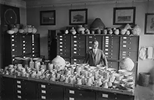 Judd Prints: Neil Merton Judd standing with Native American pottery at the Smithsonian Institution