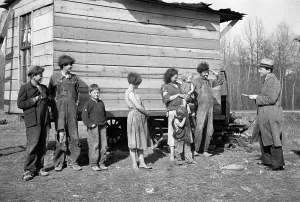Shack Prints: New Deal official investigating case of a family of nine living in field off U