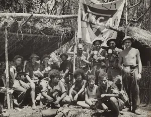 Allied Prints: New Guinean natives and Allied troops pause at a YMCA in the jungle