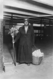 Porter Prints: New York City, African American woman porter posed with cleaning gear