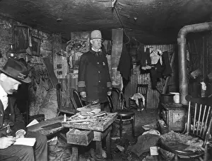 Room Prints: New York City policeman and a housing inspector in a cluttered basement rental c. 1900