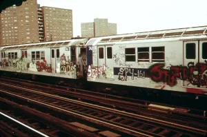 Railroads Prints: New York City Subway. A graffiti painted subway train with housing projects in the background