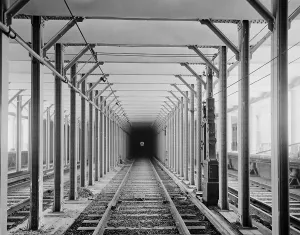 Tracks Prints: The New York City subway tracks at a station with a dark tunnel in the distance