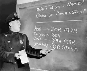 Classrooms Prints: New York Police Officer Richard Perry practices basic Spanish phrases using phonetic syllables written on blackboard