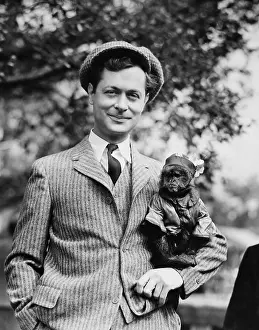 NIGHT MUST FALL, Robert Montgomery and friend on set, 1937
