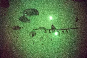 Parachutes Prints: Night vision image of Paratroopers of the 82nd Airborne jumping from C-141 Starlifter aircraft