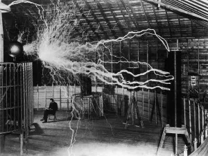 Nicholas Prints: Nikola Tesla 1856-1943 created a double exposure photograph of himself reading undisturbed by a 22 foot long discharge