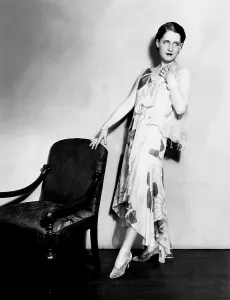 Shearer Prints: Norma Shearer, modeling a chiffon evening frock with an uneven hemline, 1929