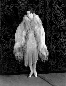 Shearer Prints: Norma Shearer, modeling a panne-velvet evening wrap embroidered in crystals and trimmed in ostrich feathers