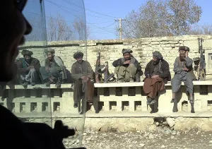 Images Dated 16th March 2011: Northern Alliance troops under General Dostum's command in Mazar-e Sharif take a break on a wall in the median of