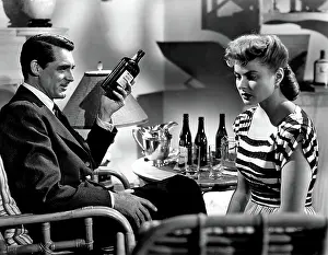 Sitting In Chair Prints: NOTORIOUS, Cary Grant, Ingrid Bergman, 1946