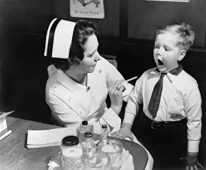 North Americans Prints: A nurse examining the teeth of a boy in New York, N.Y. ca. 1935