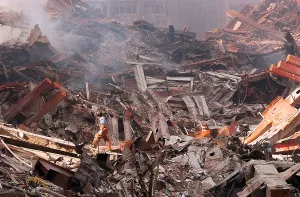 Skyscraper Prints: NYC Fire fighter walks over smouldering fires and wreckage at Ground Zero