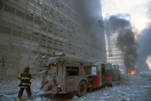 Skyscraper Prints: NYC fireman pulling water hose from fire truck after the 9-11 terrorist attack on World Trade Center