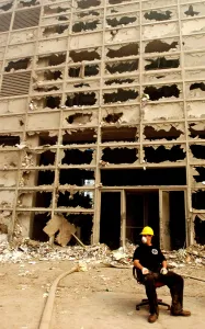 Building Collapse Prints: NYC rescue worker takes a break on an office chair from a damaged building on Barclay Street