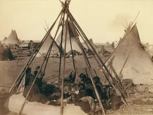 Blanket Prints: Oglala Sioux women and children inside an uncovered tipi frame near Pine Ridge Agency
