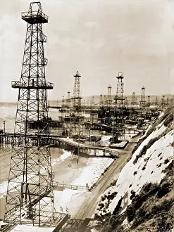 Wells Prints: Oil well derricks on the beach along the California coast. Ca. 1944