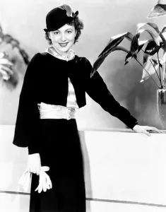 De Havilland Prints: Olivia de Havilland, modeling a black-crepe suit with ice-blue satin blouse, 1935
