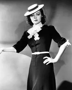 De Havilland Prints: Olivia de Havilland, modeling a spring frock of navy-blue bengaline with white accents