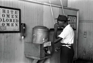 2007 Prints: Original caption reads: Negro drinking at colored water cooler in streetcar terminal