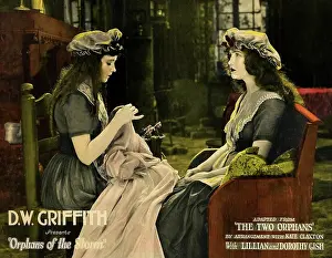 Sitting In Chair Prints: ORPHANS OF THE STORM, lobbycard, from left: Lillian Gish, Dorothy Gish on lobbycard, 1921