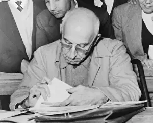 Courtroom Prints: Ousted Iranian Premier Mohammed Mossadegh reads during his Teheran treason trial