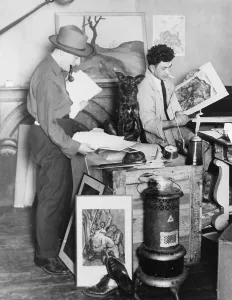 Painter William Gropper (1897-1977), and sculptor Morris Pass, prepare to travel West on their on motor truck with their dog, Munchausen. May 12, 1925
