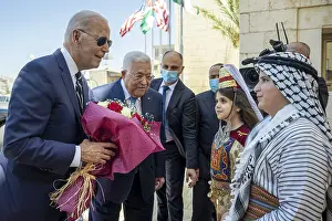 Embroidery Prints: Two Palestinian children in traditional costumes give flowers to President Biden during the arrival ceremony