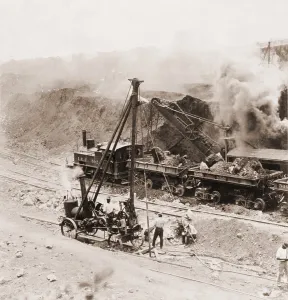 Digging Prints: Panama Canal construction. A steam shovel loads excavated rocks into railroads cars at Gatun Dam site